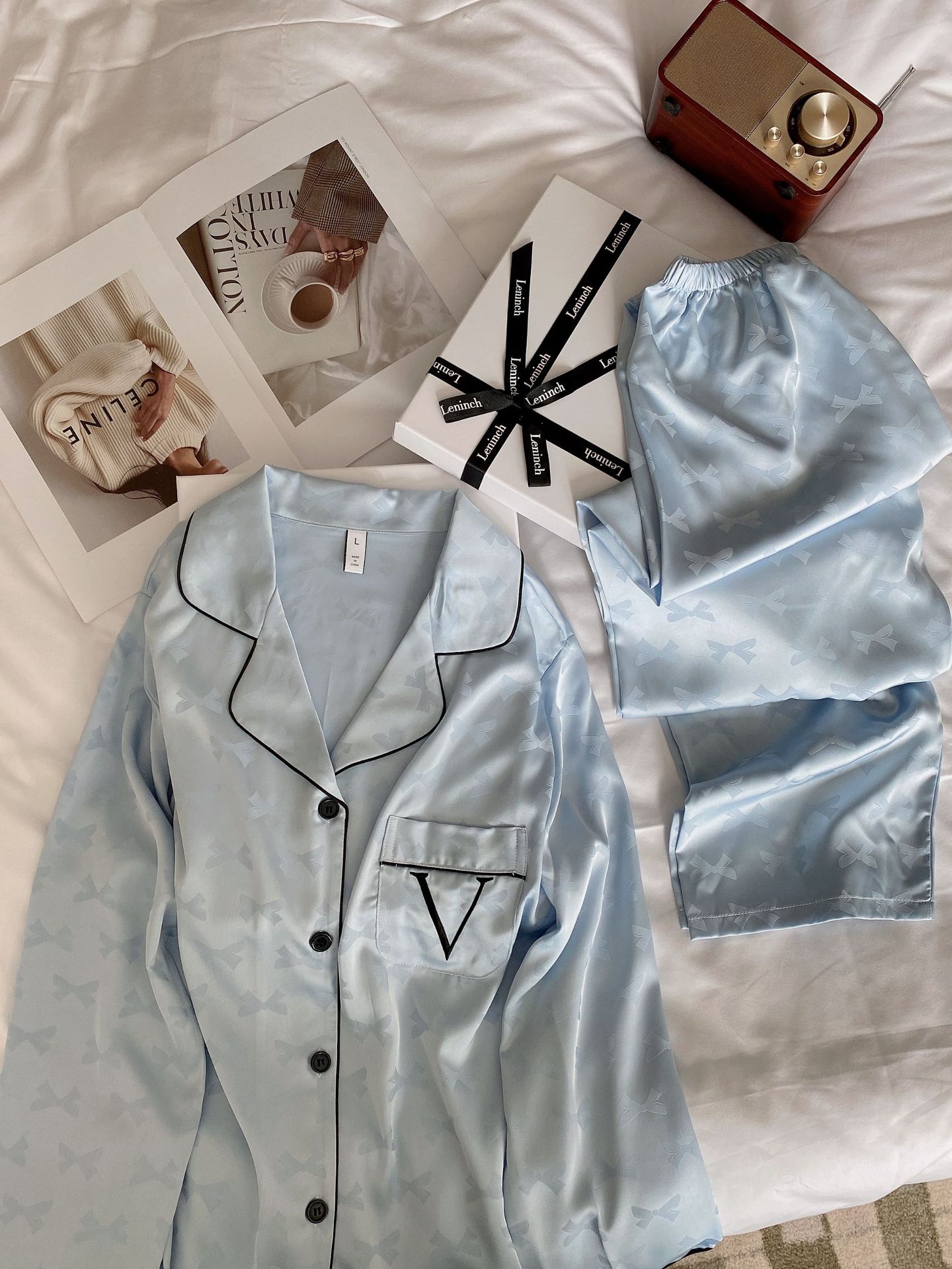 Elevate your loungewear with our elegant light blue ice silk pajamas. Featuring a delicate bow pattern and a soft, breathable fabric, this set is perfect for any occasion.